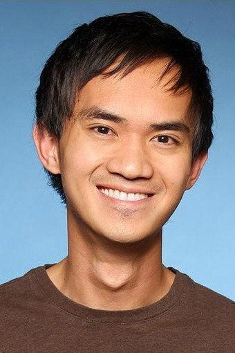 Comedic headshot: Zedrick smiling broadly against a blue backdrop